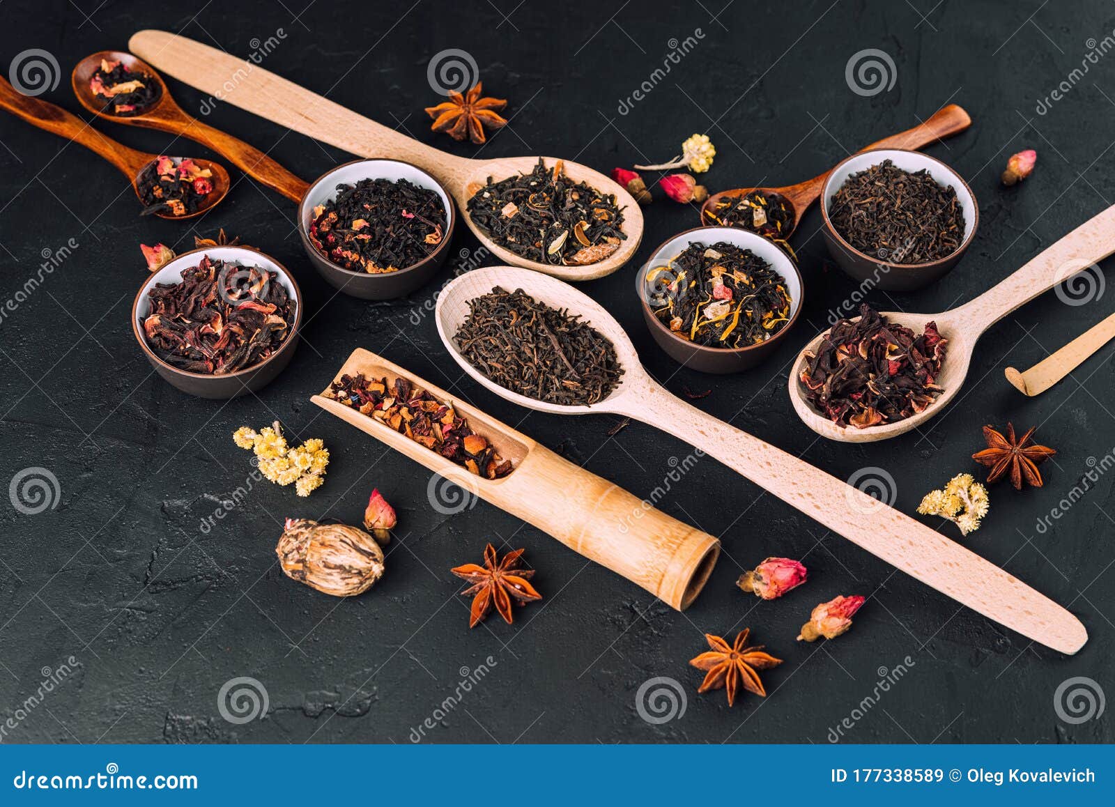 Assorted Dried Tea Leaves in Bowls and Wooden Spoons on a Concrete ...