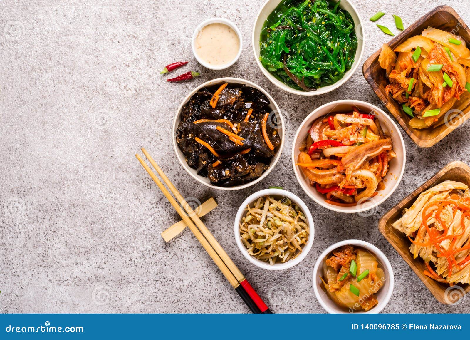 Assorted Korean Pickled Food and Chopsticks on Gray Background Stock