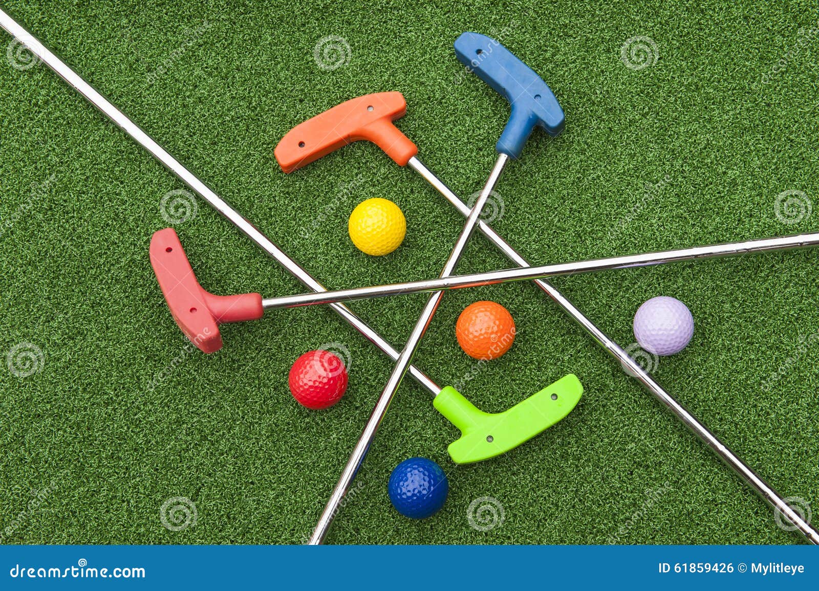 assorted miniature golf putters and balls