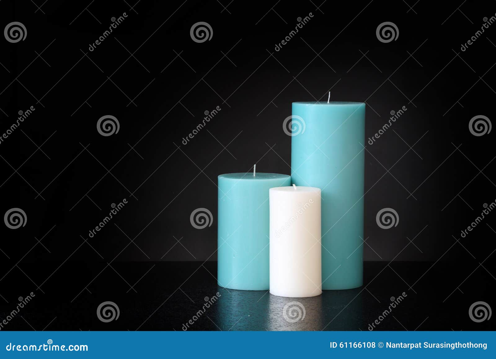 Assorted Size Candles, Blue and White Isolated on Dark Backgroun Stock