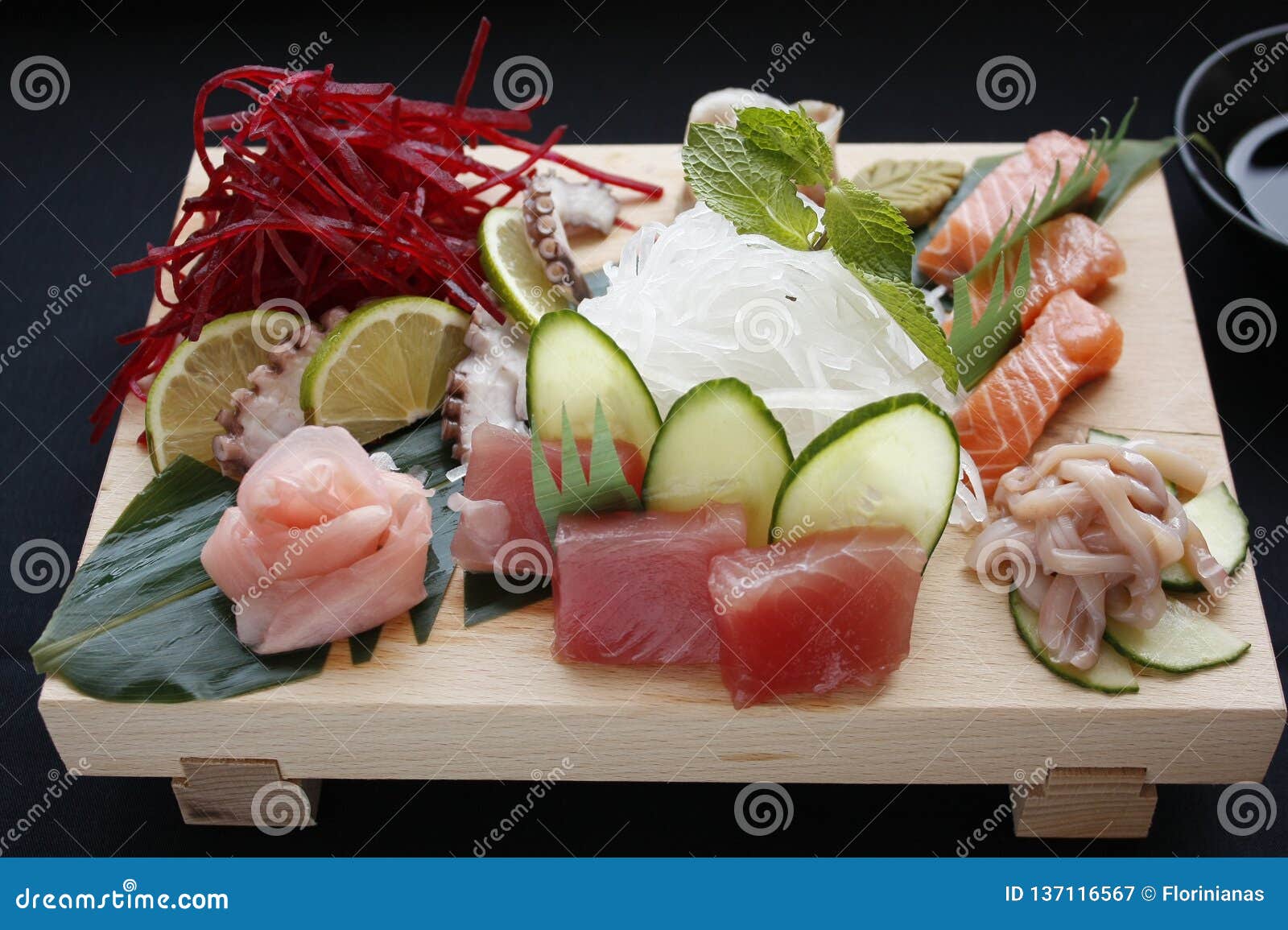 Assorted Types of Sushi on Bamboo Table with Hashi Chopsticks and Shoyu