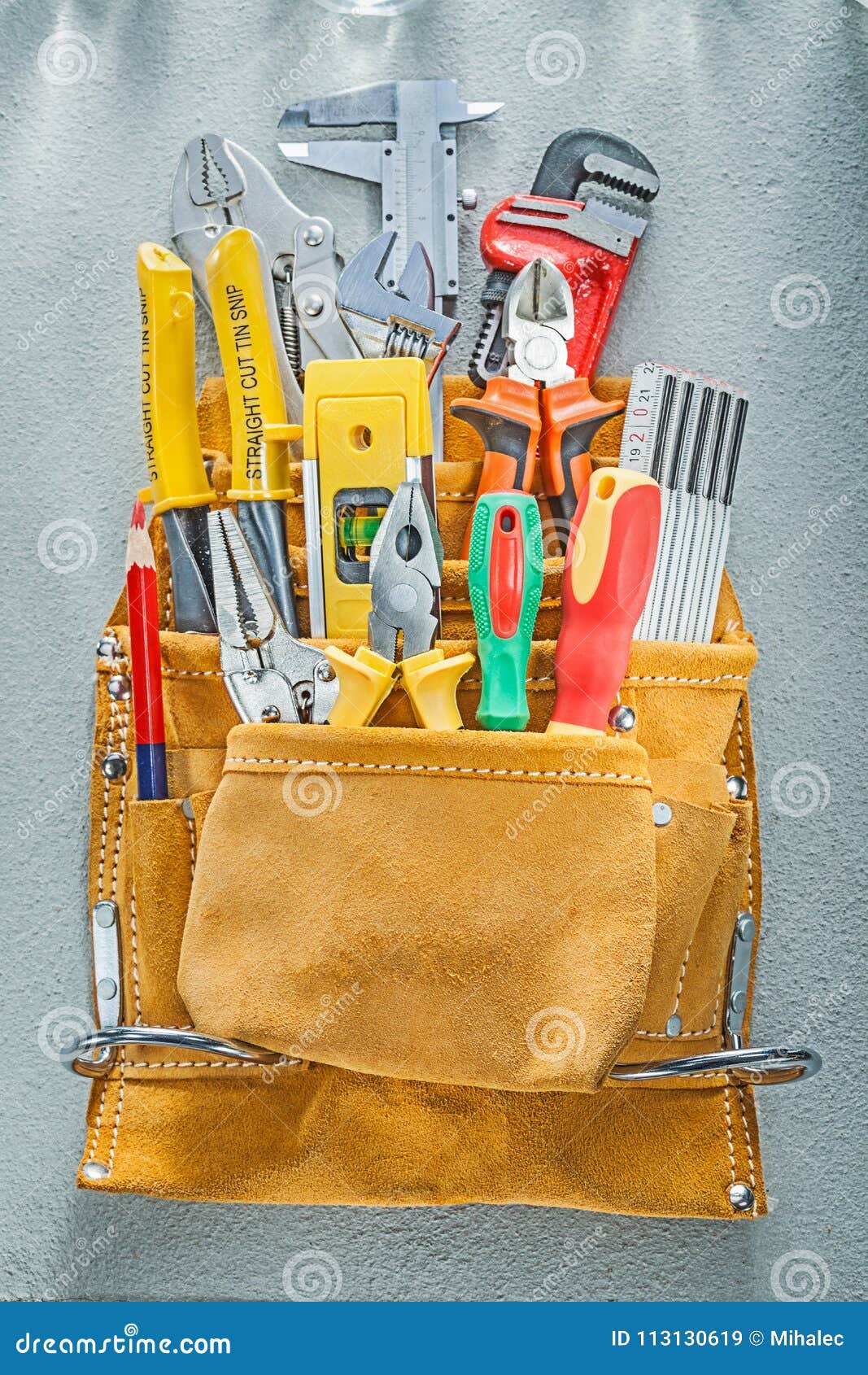 Assortment of Construction Tooling in Tool Belt on Concrete Back Stock
