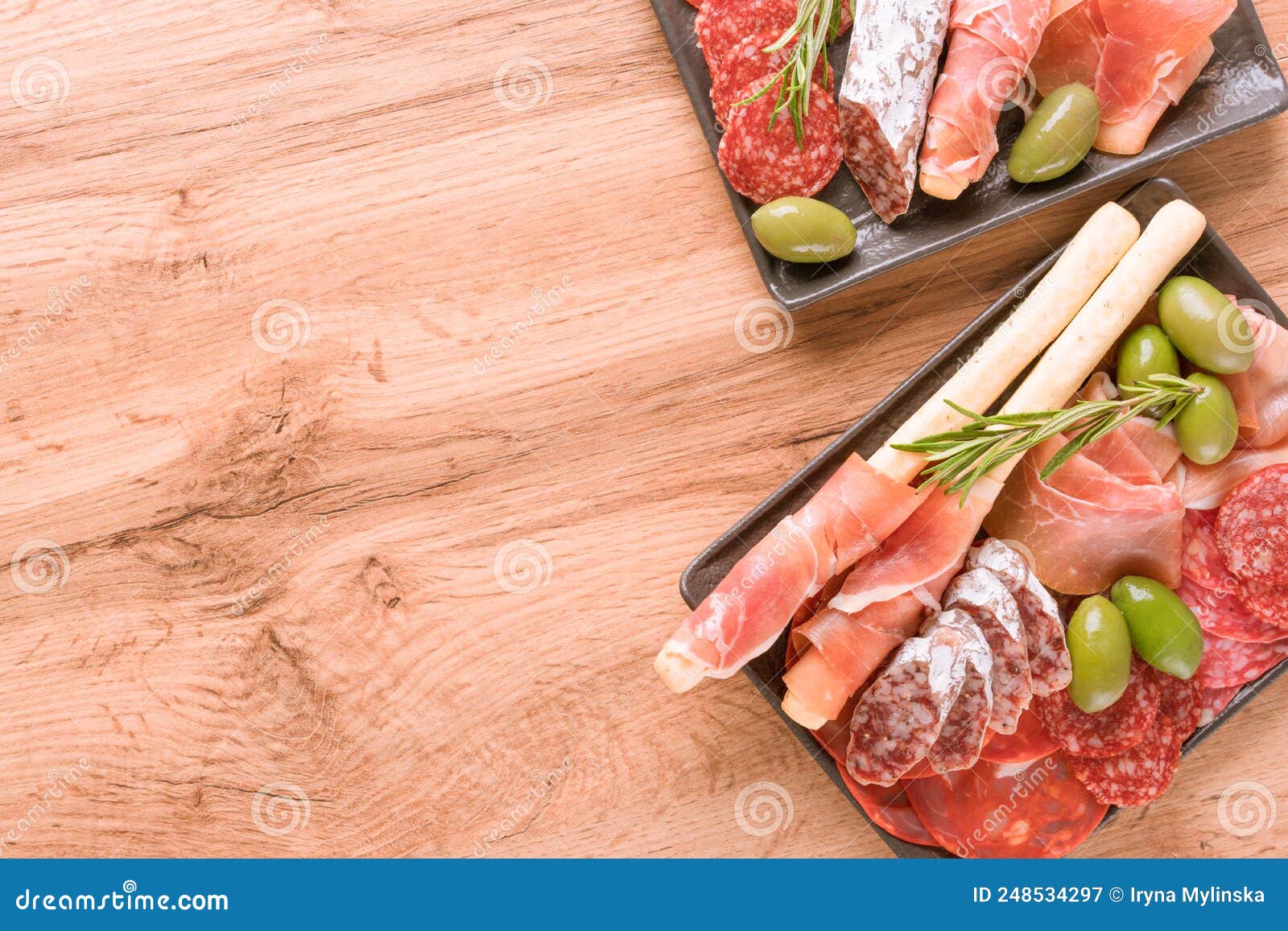 assortment of different meat snacks, charcuterie plates with several types of sausages - salami, bresaola, proscuitto