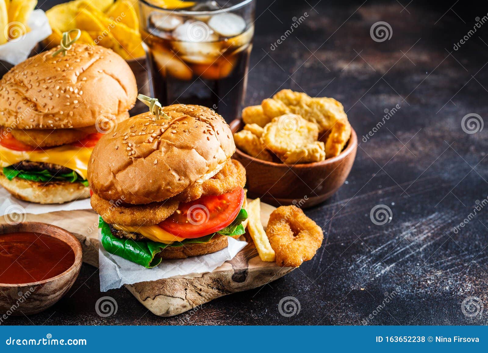 Assortment of Fast Food. Junk Food Background. Cheeseburgers, French Fries,  Nachos, Donuts, Soda and Nuggets on Dark Background Stock Photo - Image of  fast, junk: 163652238