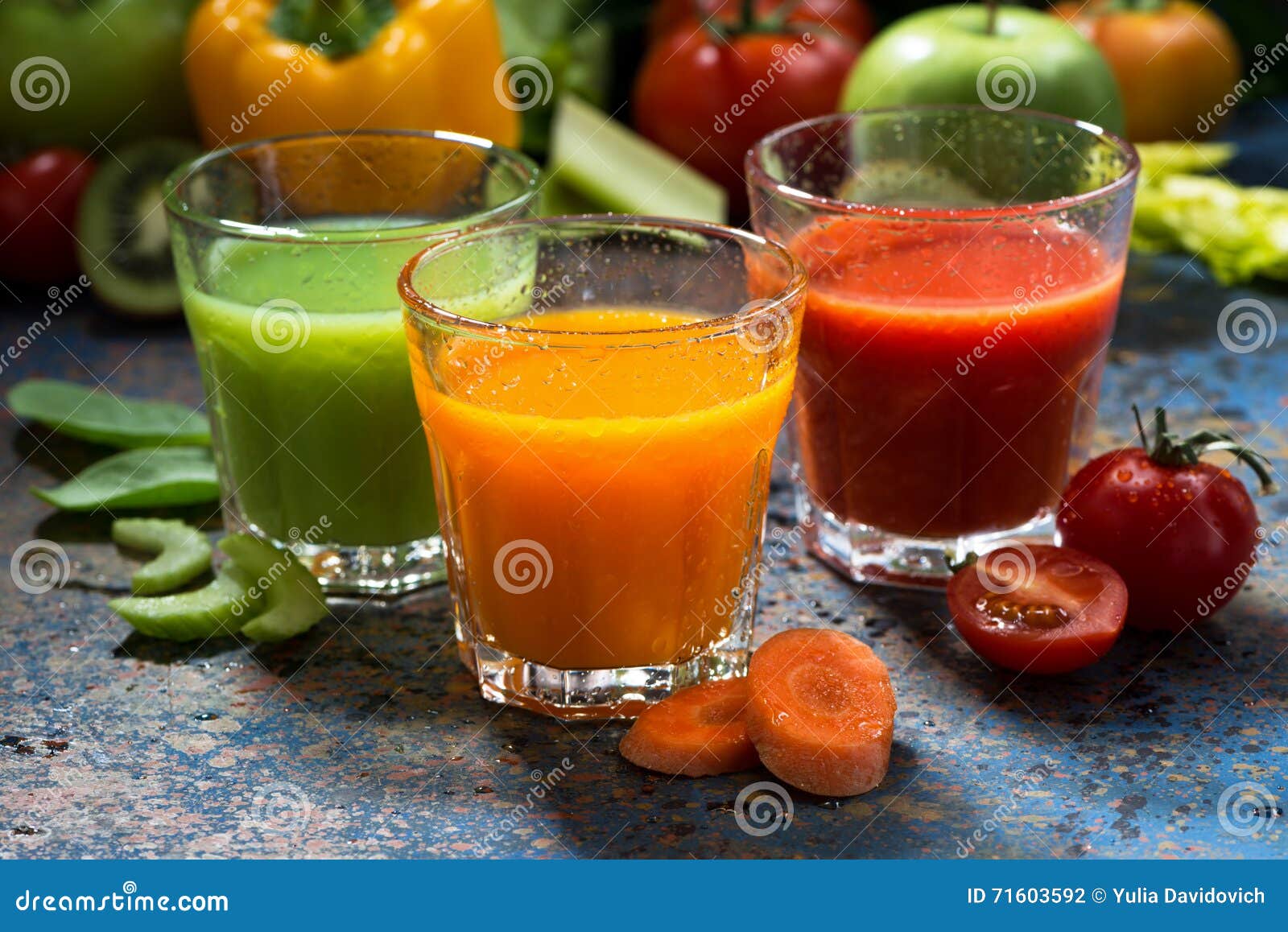 Assortment of Fresh Vegetable Juices on a Blue Background Stock Photo