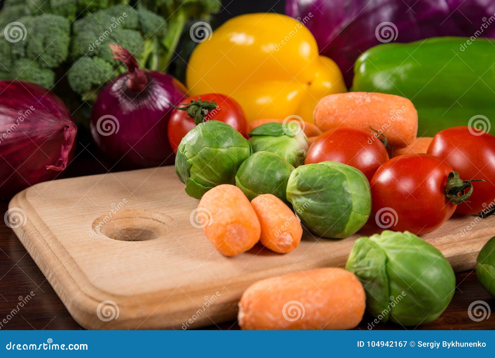 assortment of fresh vegetales on cutting board