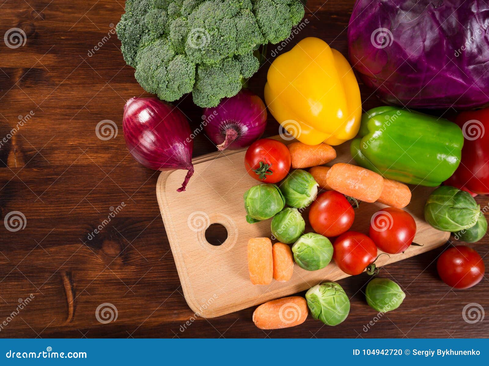 assortment of fresh vegetales on wooden table with copyspace