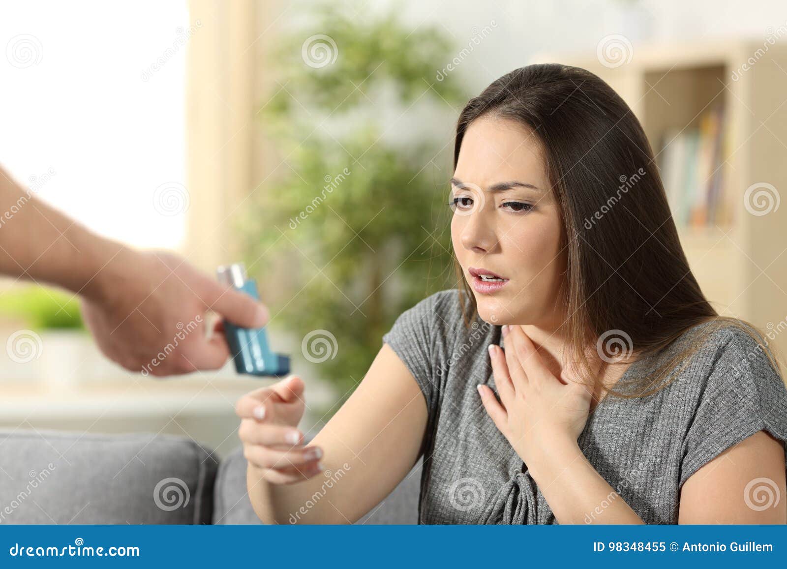 asthmatic girl suffering an attack and receiving inhaler