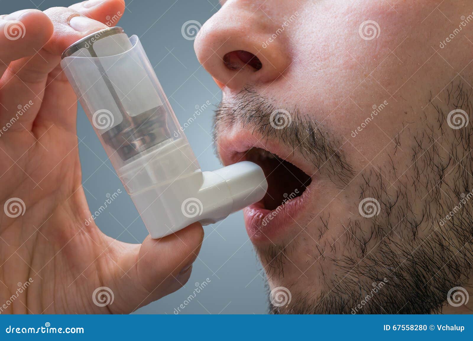 asthmatic man suffers from asthma and is using inhaler