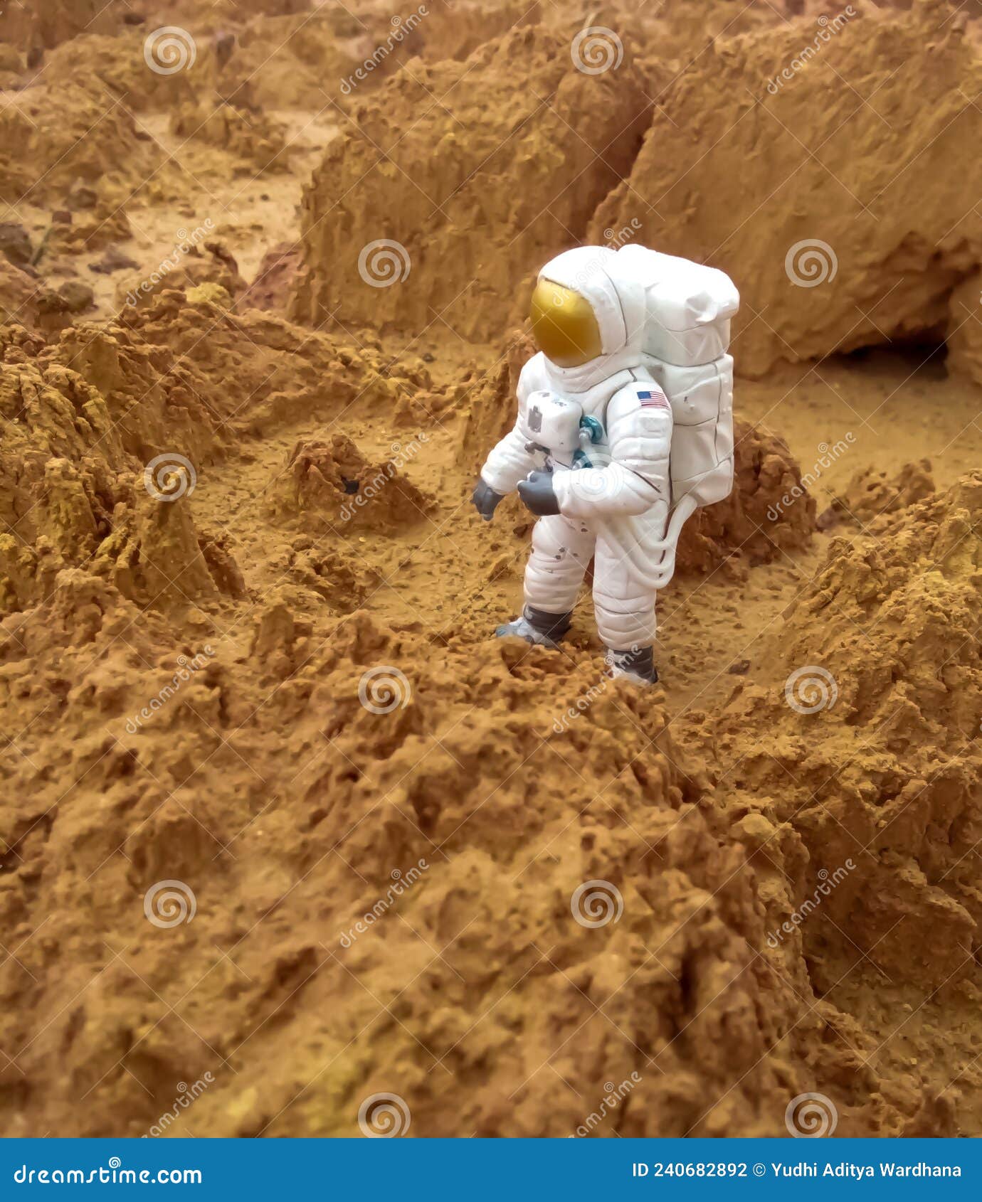 astronaut action figure toy as if on a foreign planet