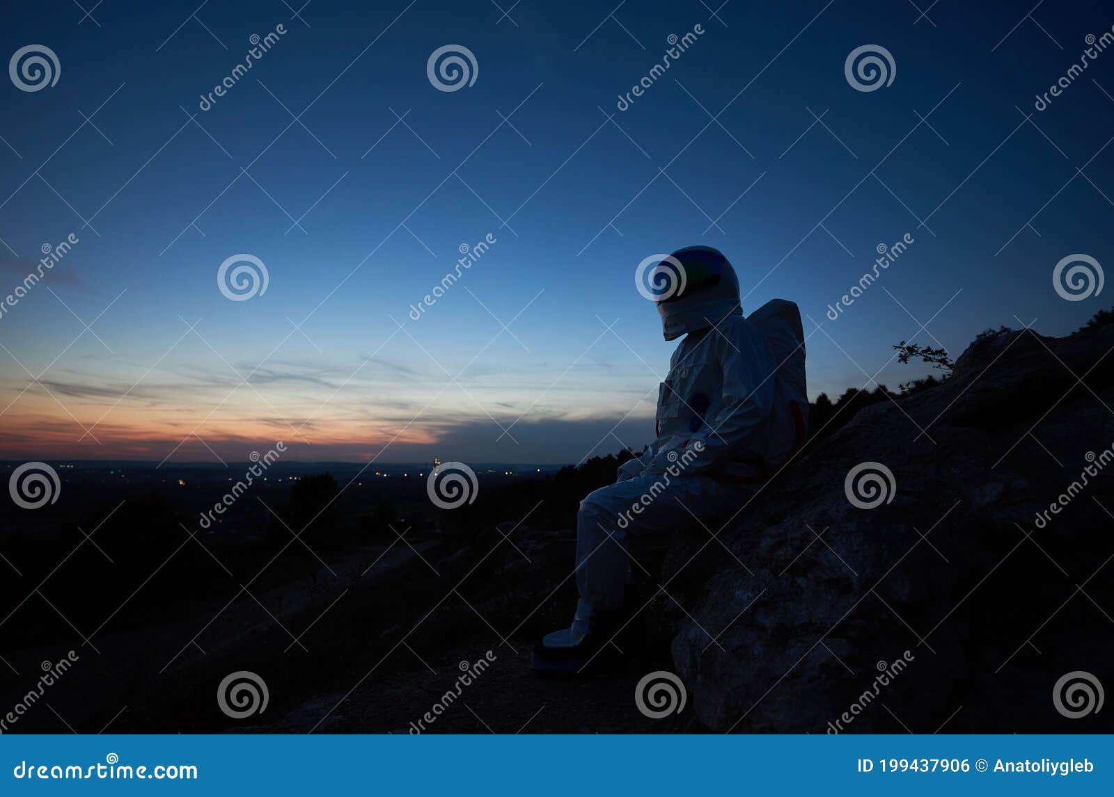 Astronauta Sentado En Una Colina Rocosa Al Atardecer Foto de archivo -  Imagen de cielo, azul: 199437906