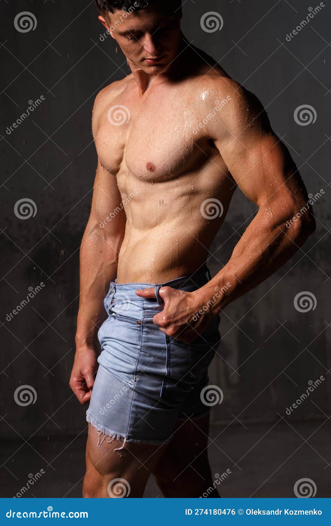 Athlete Bodybuilder Trains in the Studio in the Rain. Stock Photo