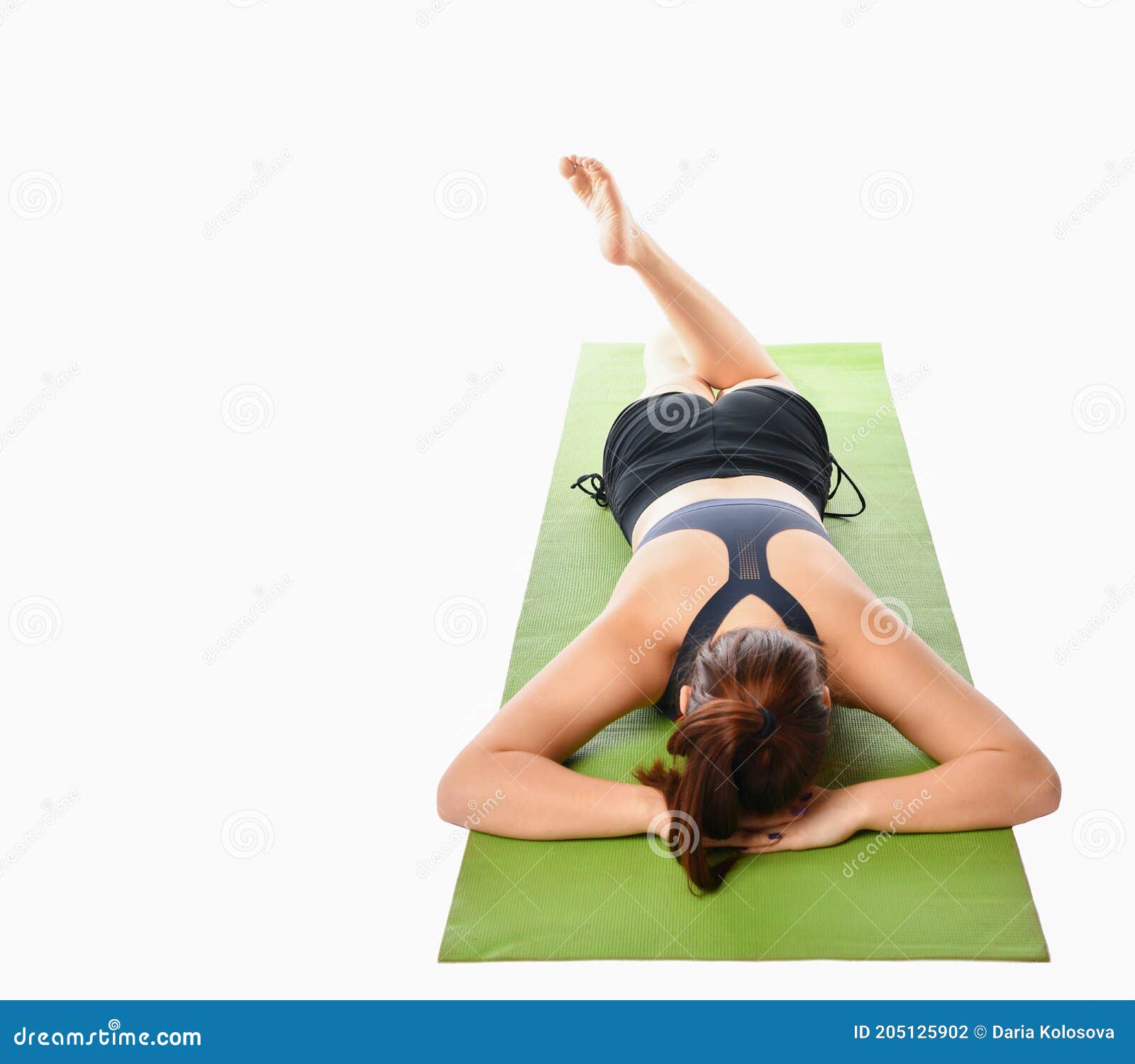 Lying down on the yoga mat. Young caucasian woman with slim body shape is  indoors at daytime 15363282 Stock Photo at Vecteezy