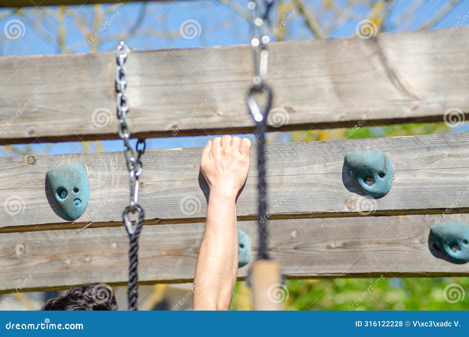 athlete hand at a hanging obstacle at an obstacle course race, ocr