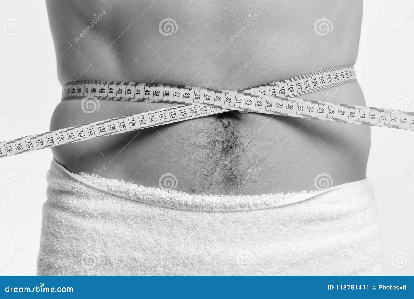 athlete measures waist or sixpacks sports and weight loss concept measures for weight loss