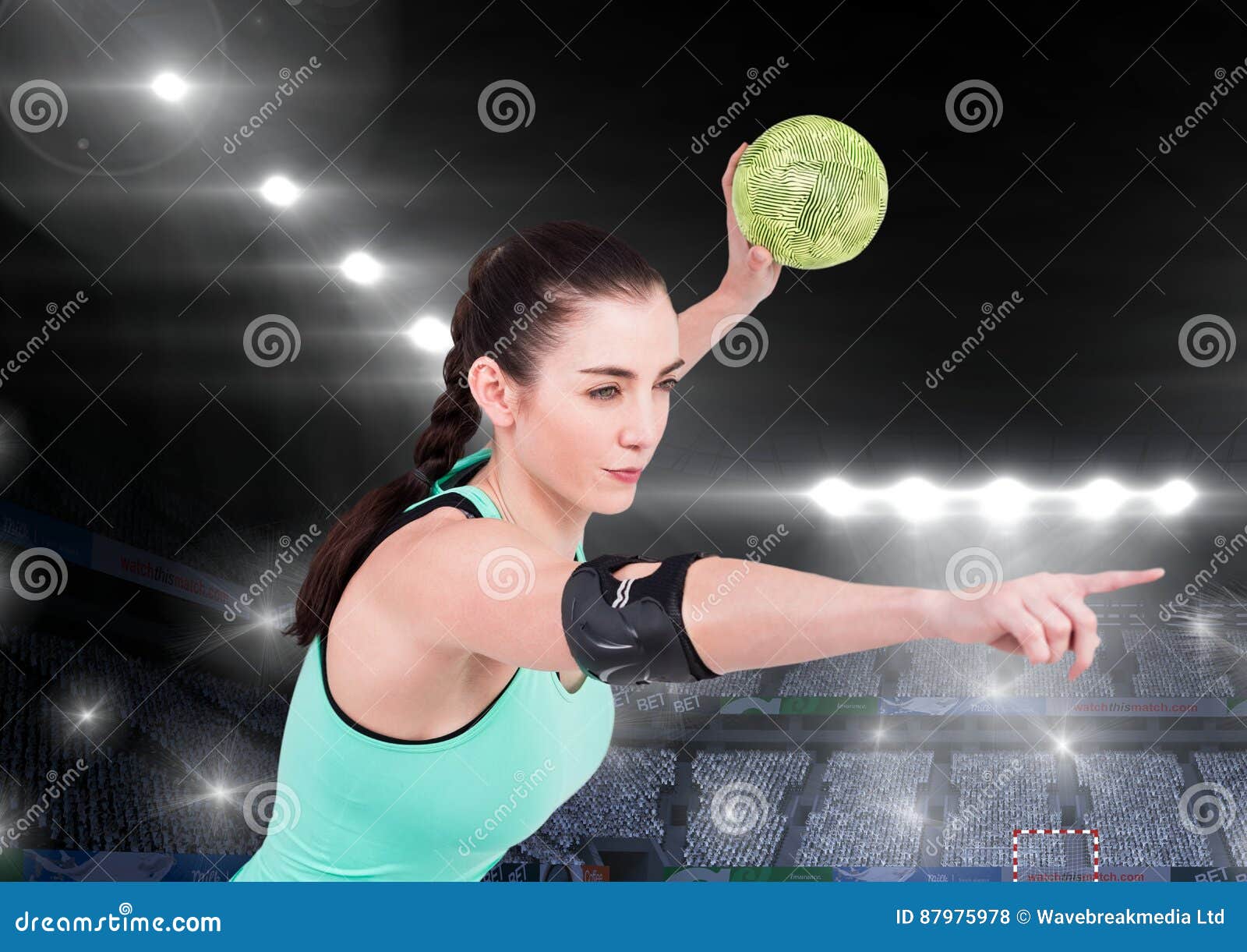 Athlete Playing Handball Against Stadium in Background Stock Photo