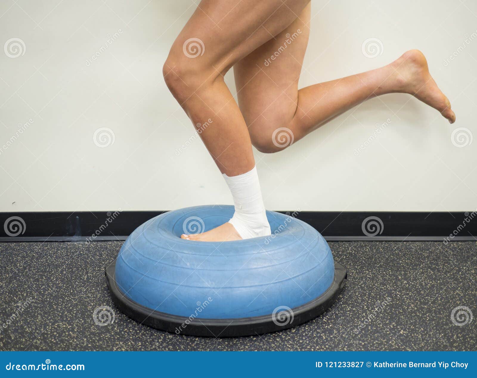 athlete with a sprained ankle doing strengthening and balance exercises on a bosu ball