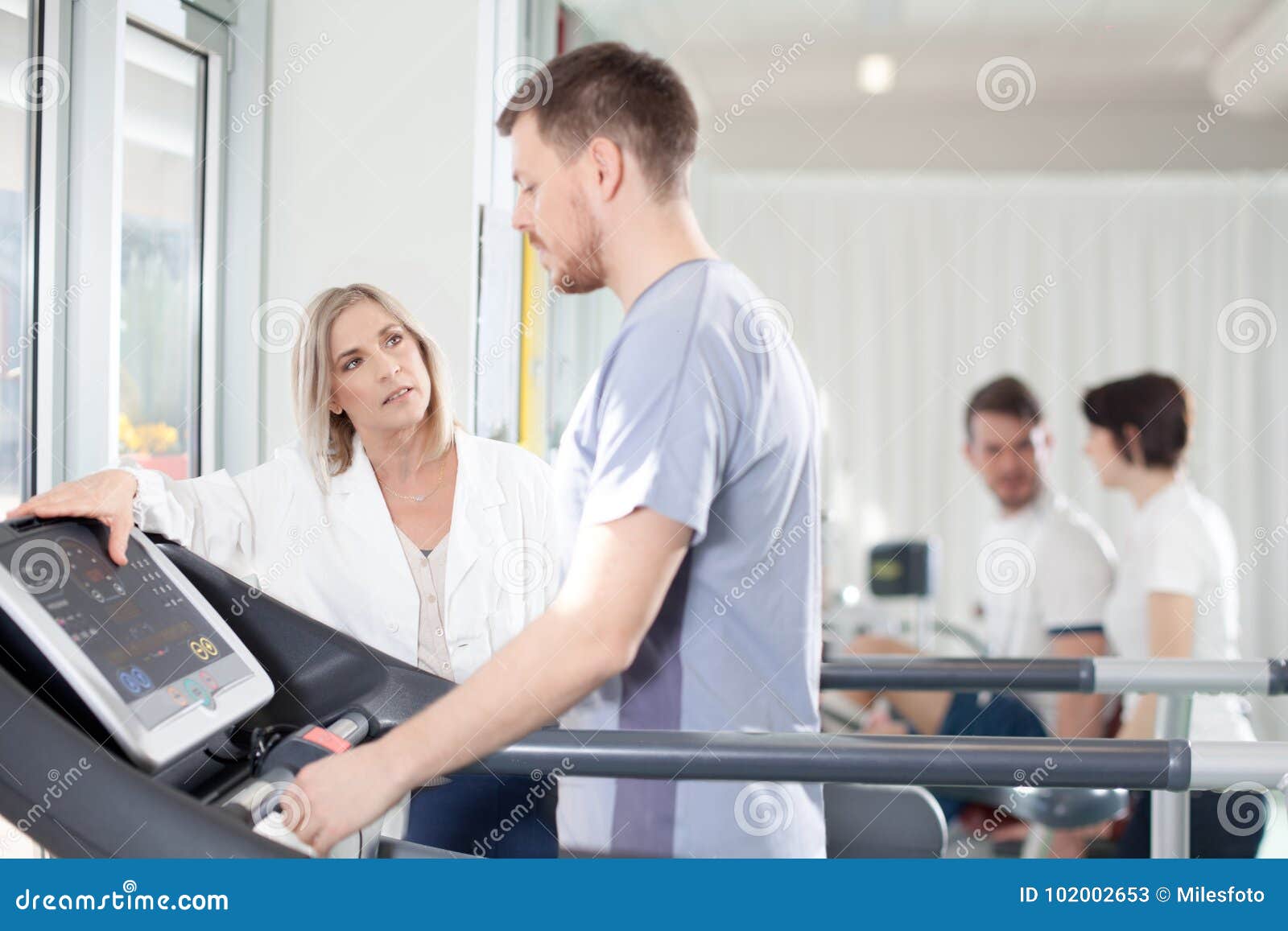 athlete on a treadmill with physiotherapist doctor