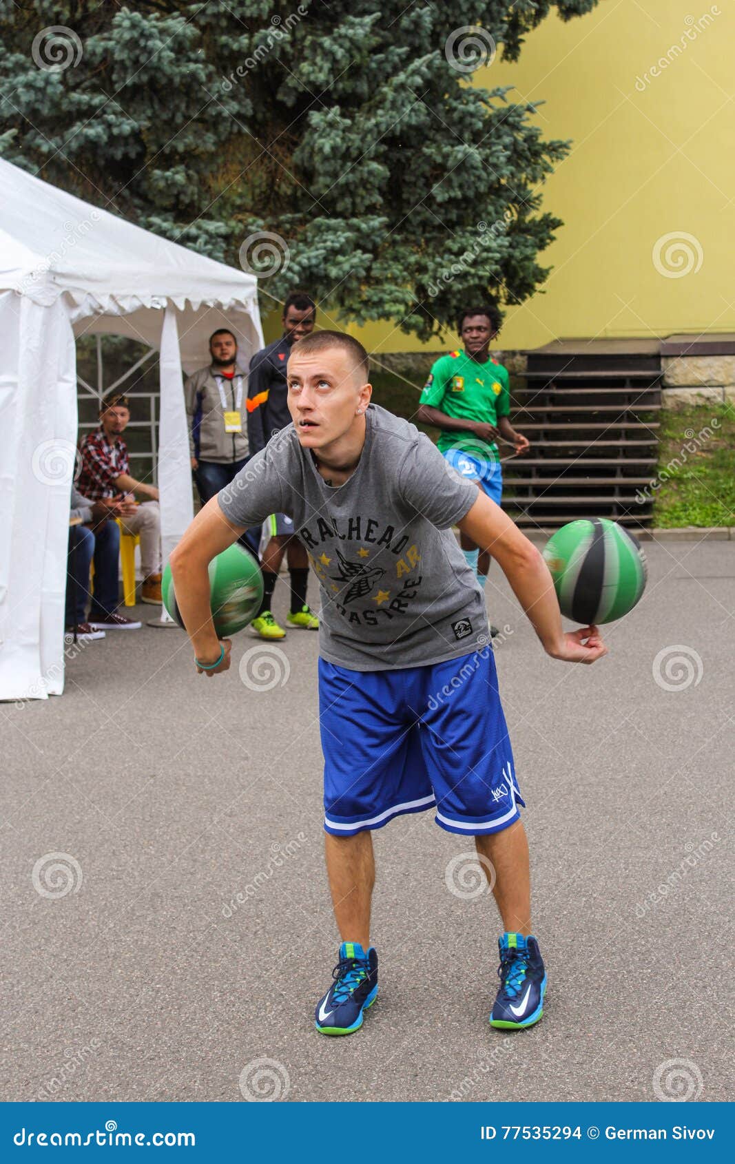 An athlete with two balls. editorial stock image. Image of action