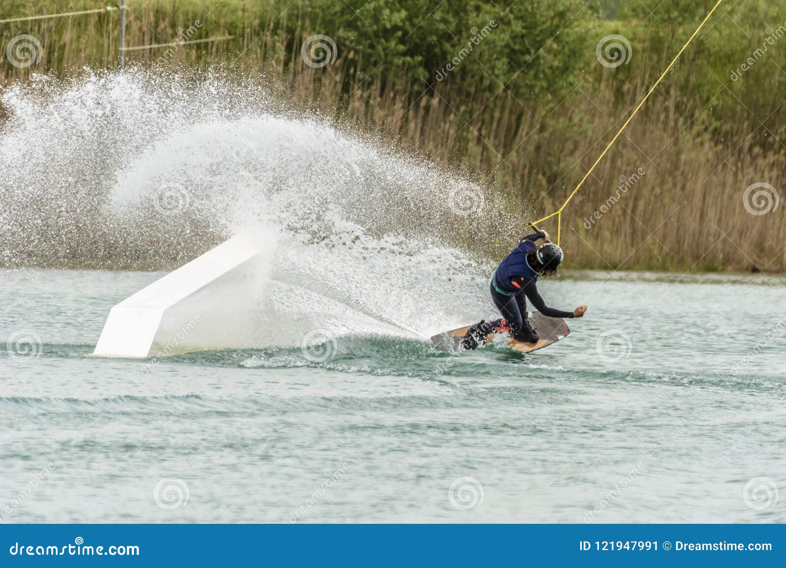 athlete woman is wakeboarding at the cable park