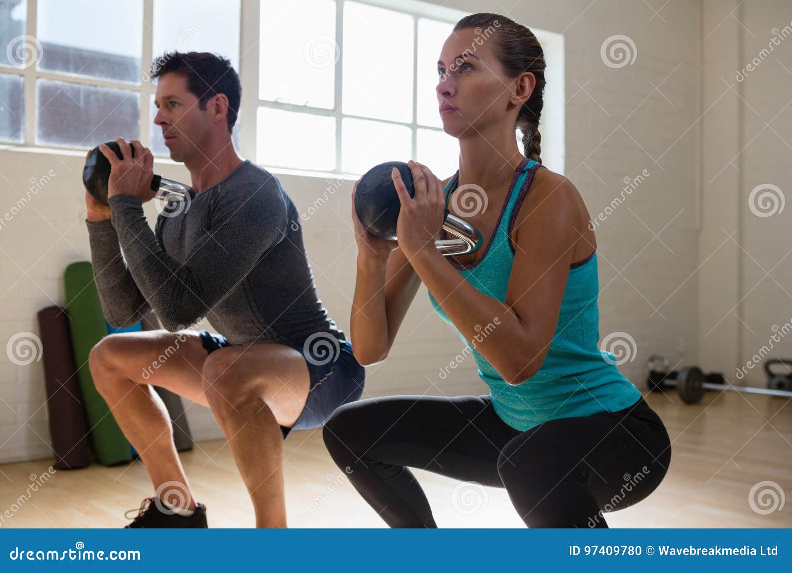 Athletes Looking Away while Lifting Kettlebells Stock Photo Image of