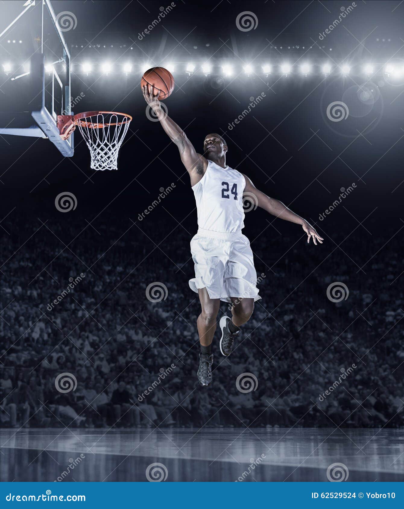 athletic african american basketball player scoring a basket