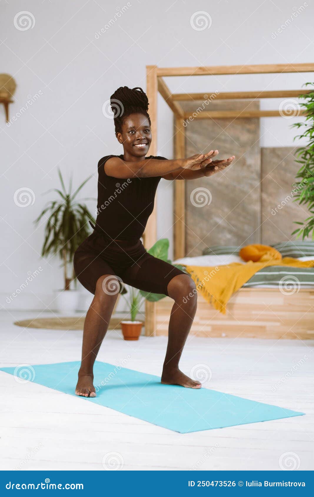 Athletic Afro American Woman With Smile Squatting With Arms Extended Forward Training On