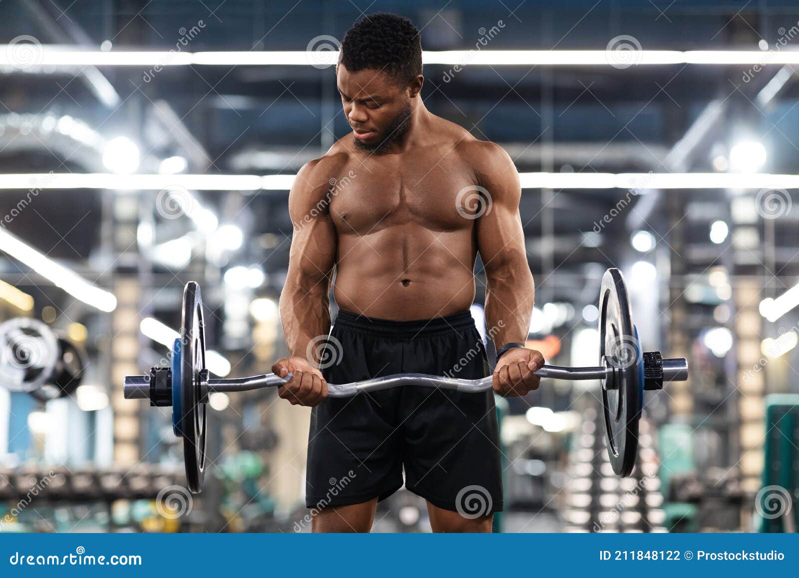 Athletic Black Man Working on Arms and Chest Musculs Stock Photo