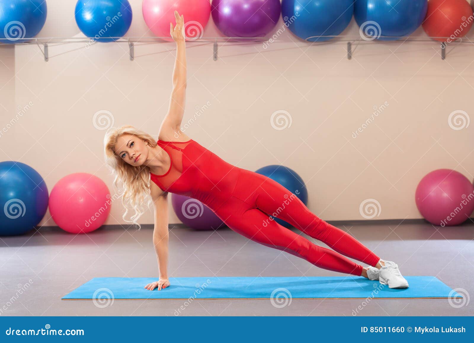 athletic girl doing planking exercise in the fitness room. sport woman in sportswear workout