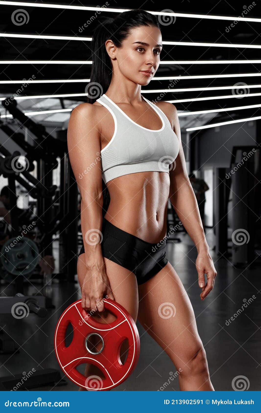 Athletic Girl Working Out in Gym. Fitness Woman with Flat Belly