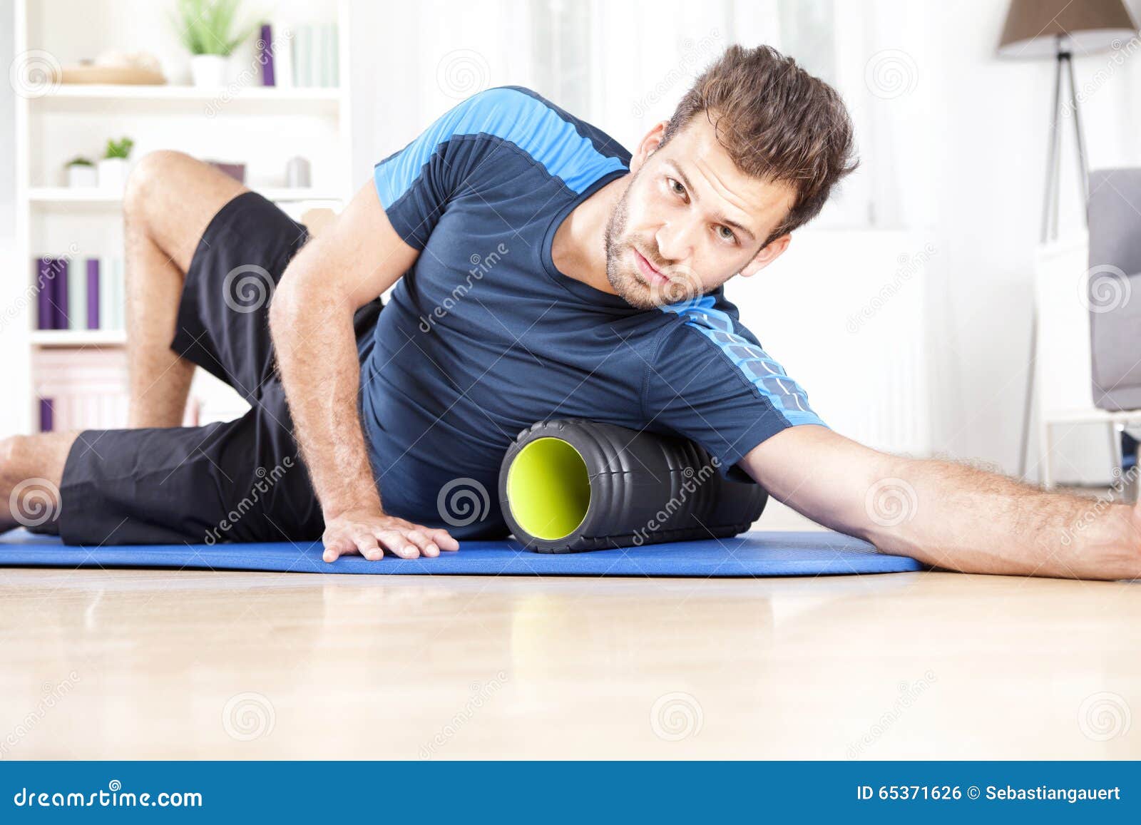 Athletic Guy Using Foam Roller in Exercise Stock Photo Image of