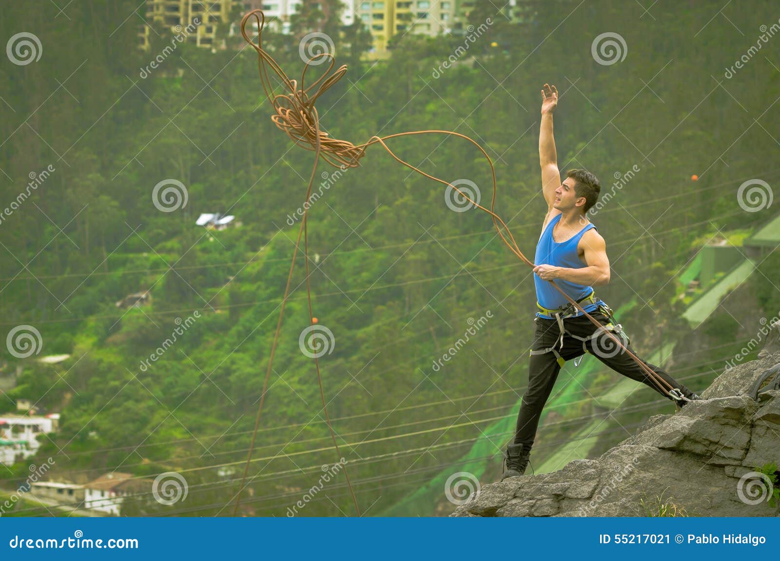 Athletic Man Standing on Cliff Throwing Rope Down Stock Image Image