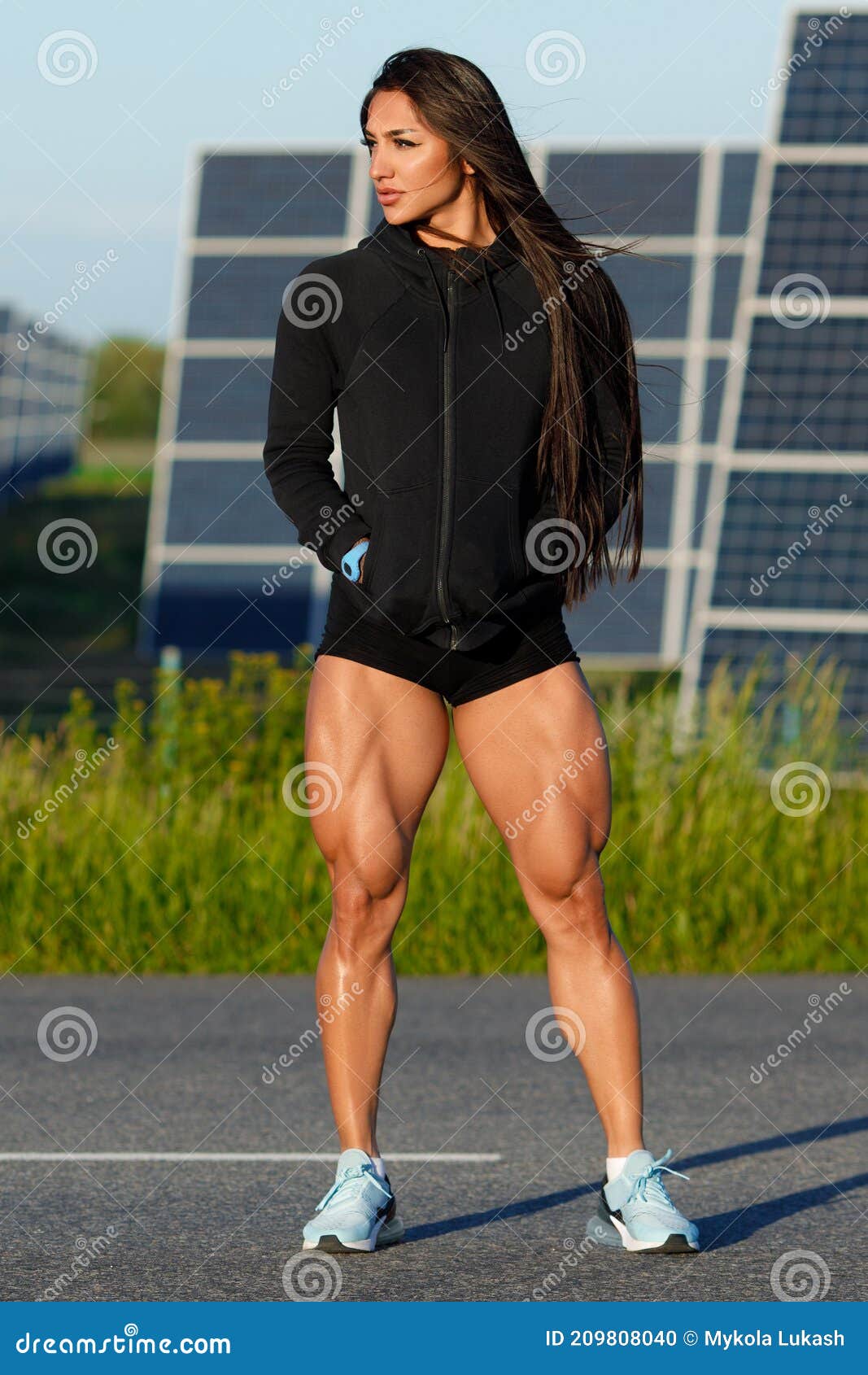 Athletic Woman with Big Quads. Muscular Girl Posing Outdoor