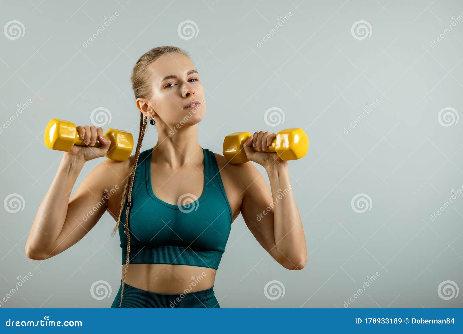 Athletic Woman With Dumbbells In Hands On A Gray Background Fitness Banner Fitness Motivation Photo Of A Muscular Stock Image Image Of Athletic Female