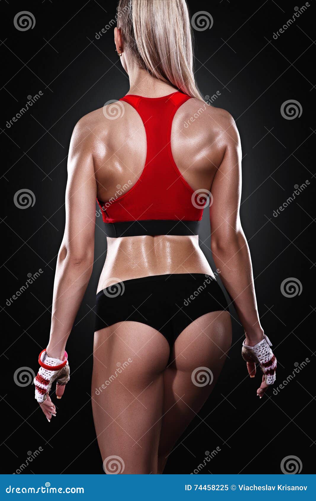 athletic young woman showing muscles of the back