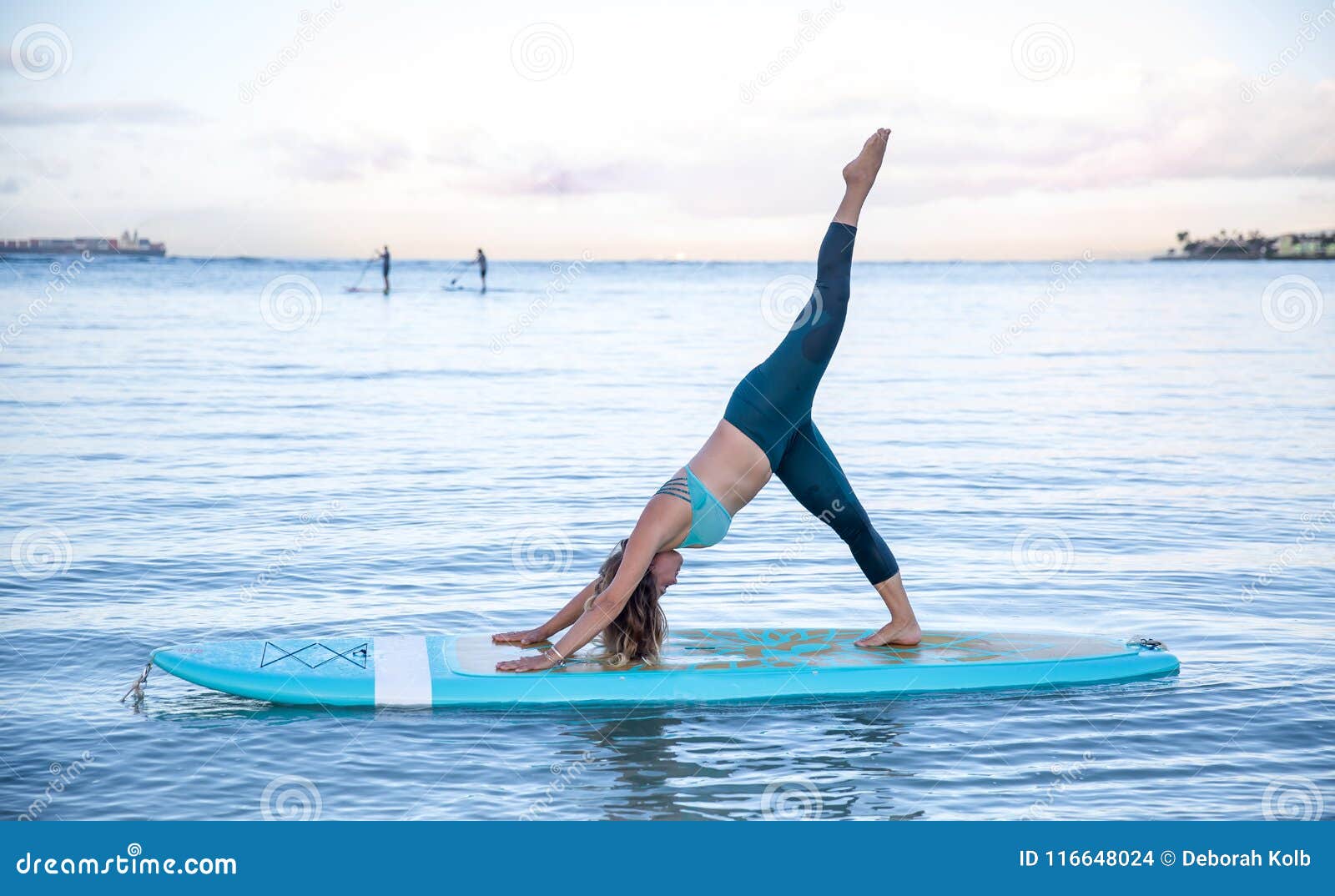 Athletic Young Woman in SUP Yoga Practice Side Bend Leg Lift Pose in ...