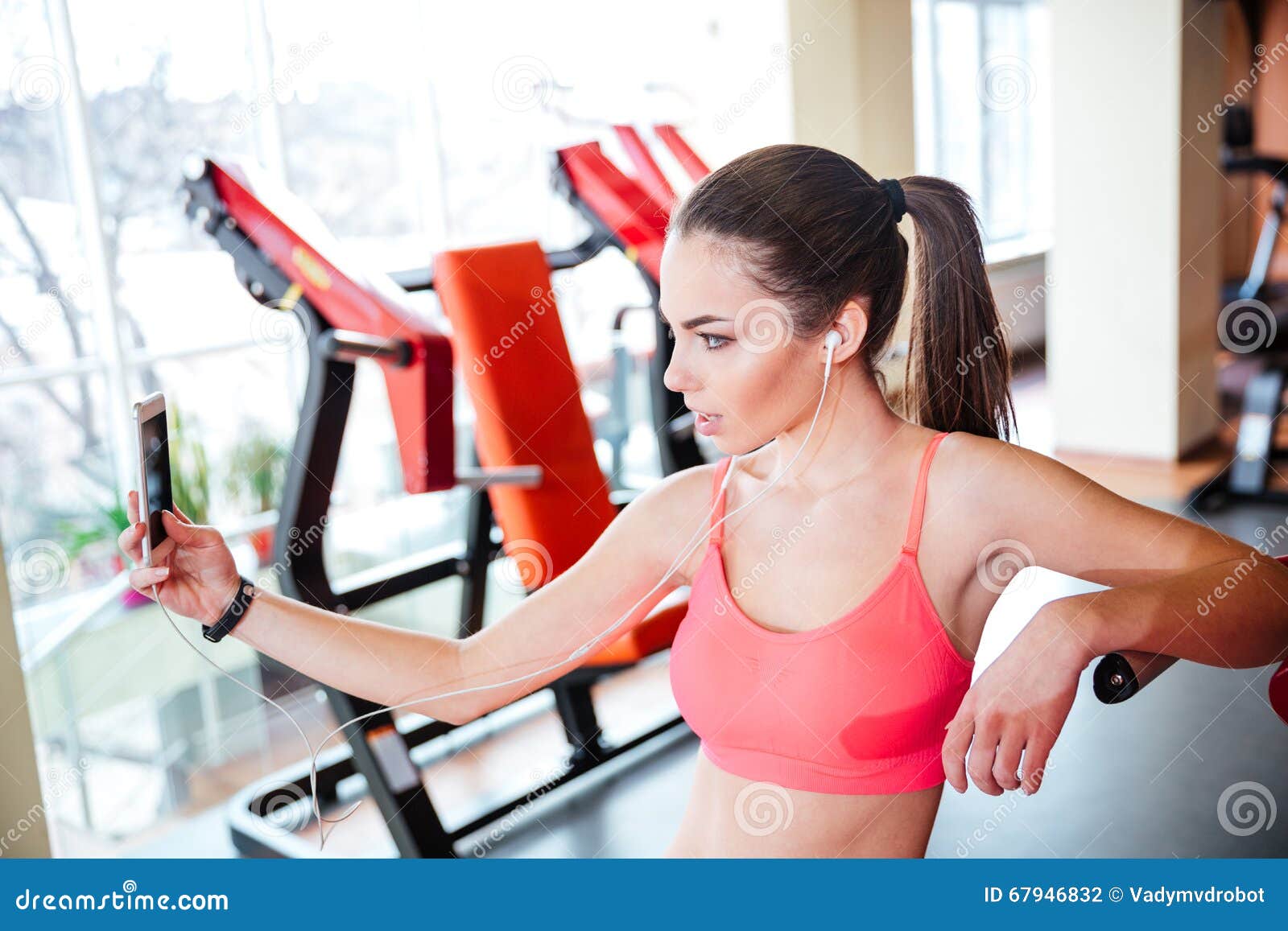 Sport donna prendendo selfie davanti a uno specchio in palestra