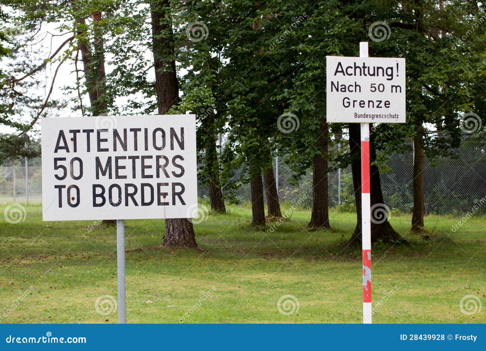 attention sign posted at checkpoint alpha in east germany