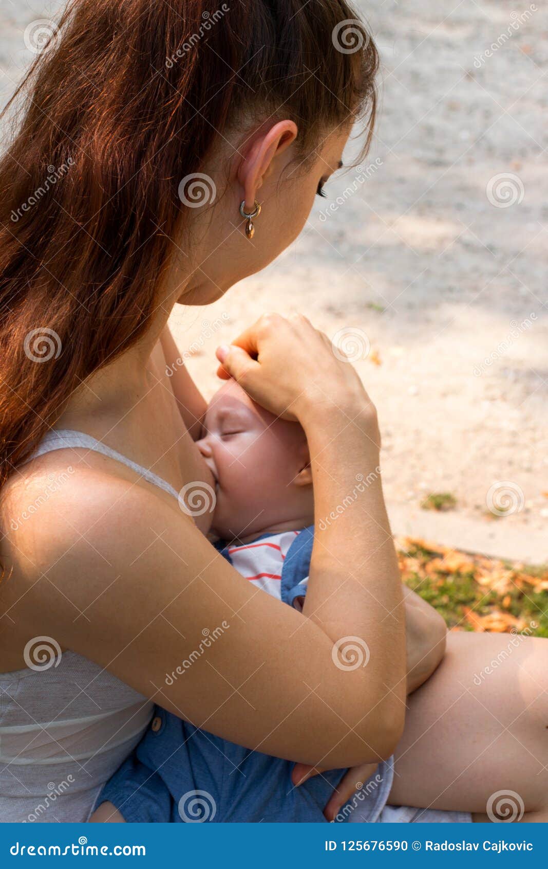 Young Mother Give Suck Her Breast Milk To Little Baby Outside Stock Photo -  Image of female, feeding: 125676590