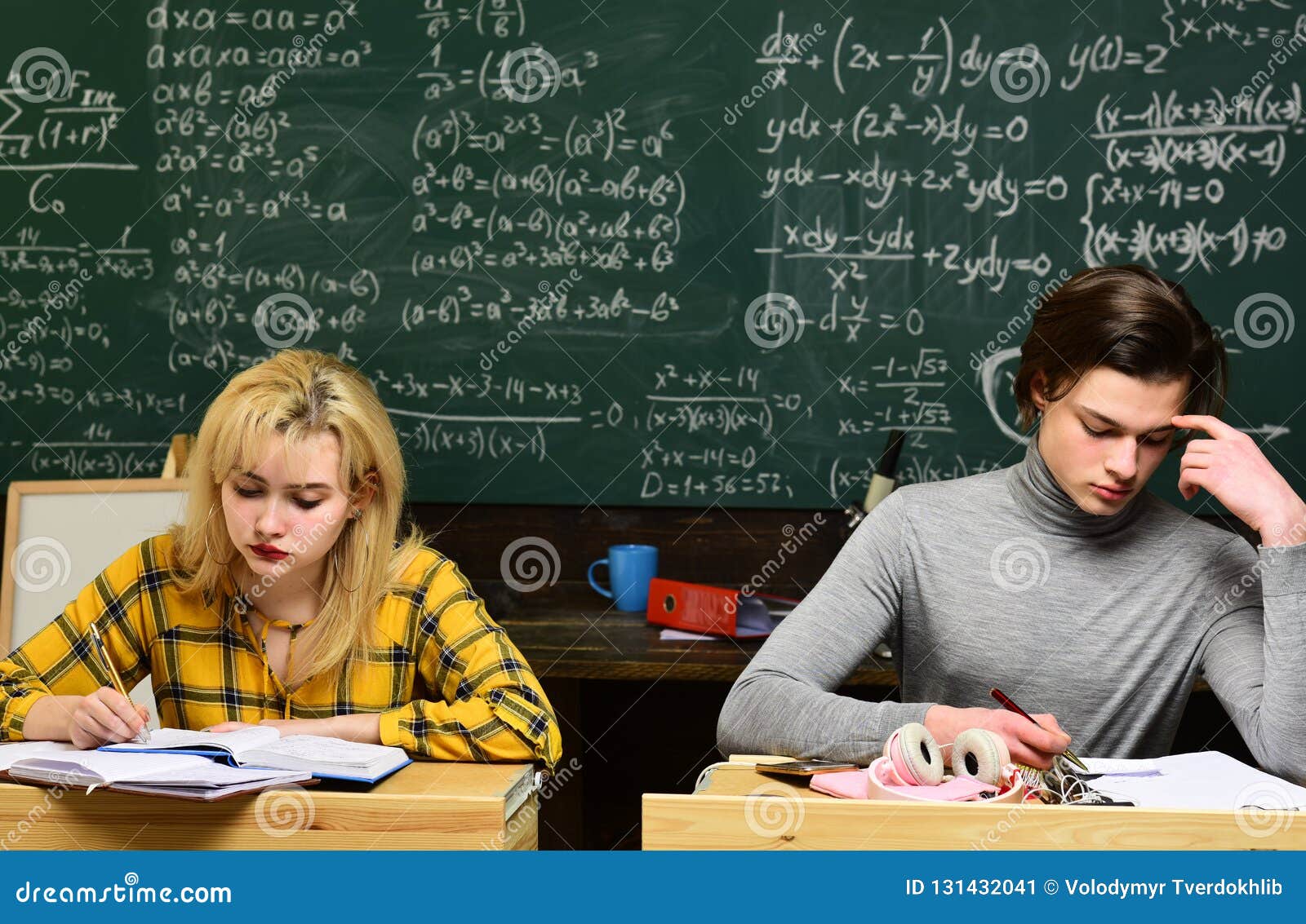 Attentive Students Writing Something In Their Note Pads While