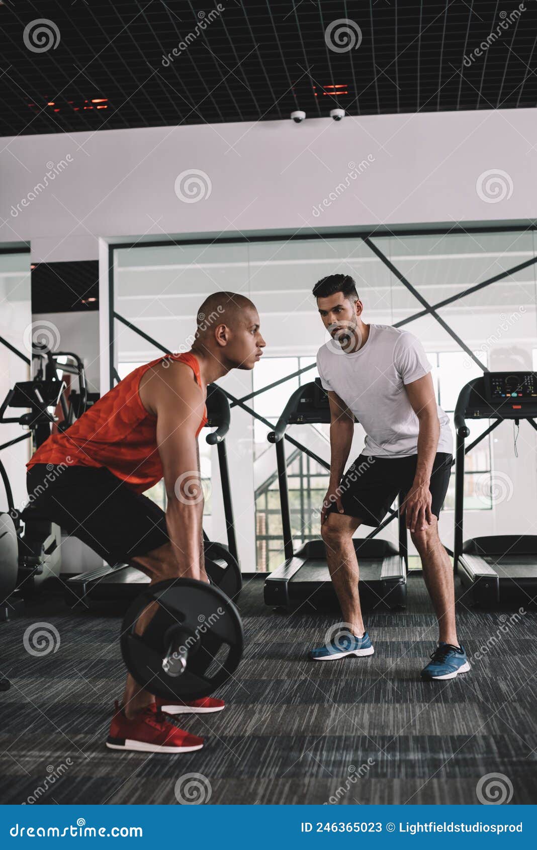 Attentive Trainer Instructing African American Sportsman Stock Image