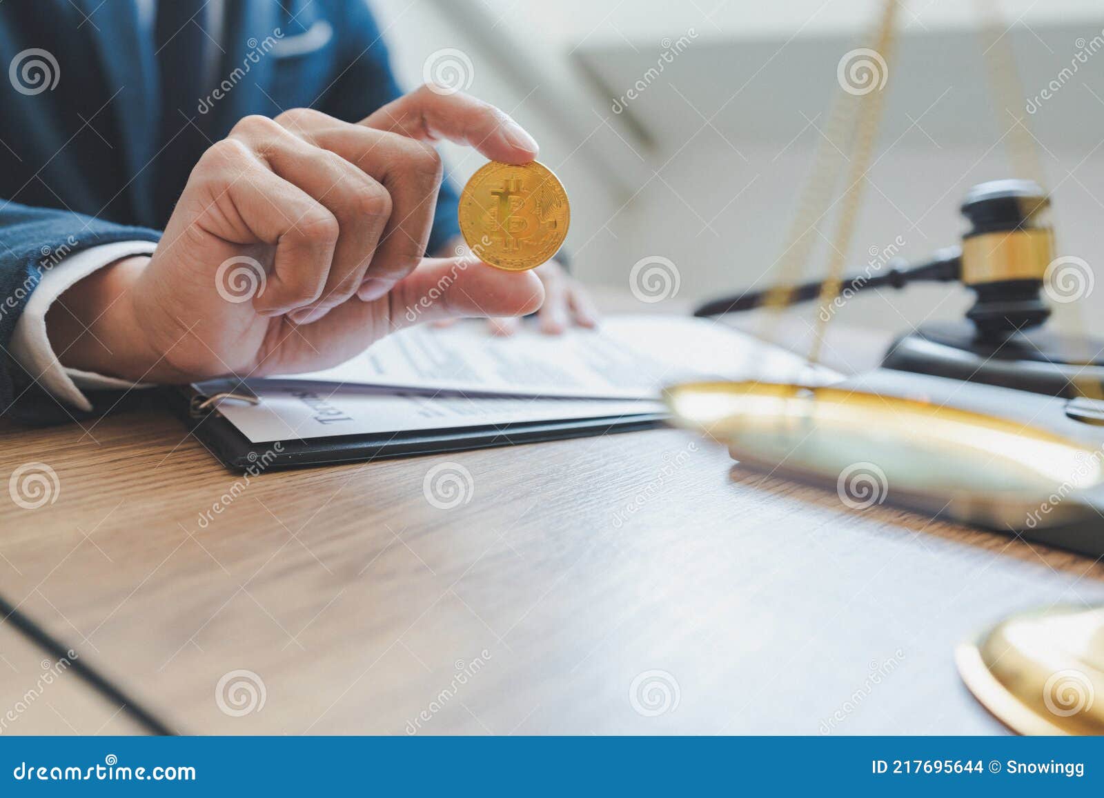 An Attorney Holds the Golden Coin in Right Hand. There are Law Hammer