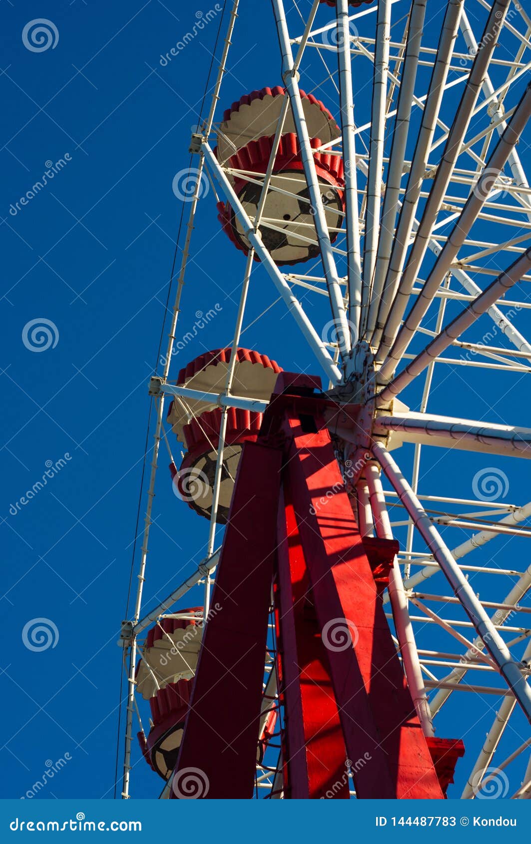 Attractions in Spring City Park Ferris Wheel Over Blue Sky Stock