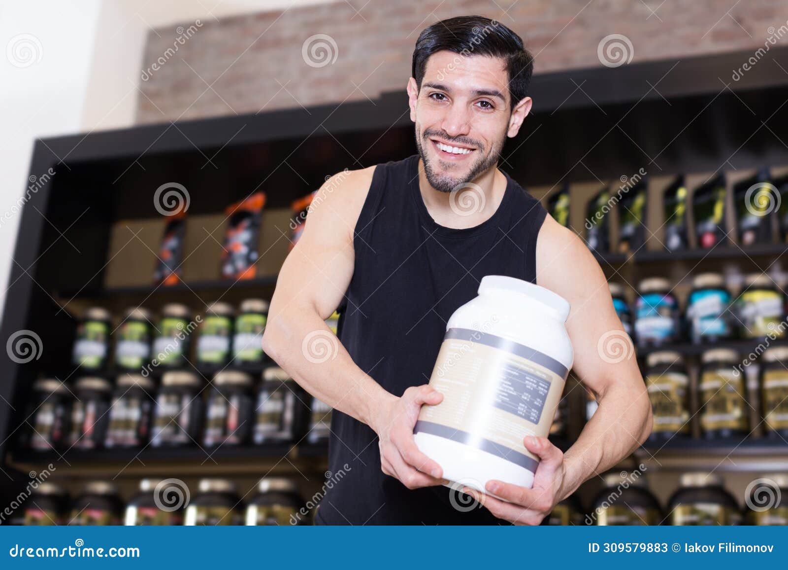 attractive athletic man seller demostration sport nutrition