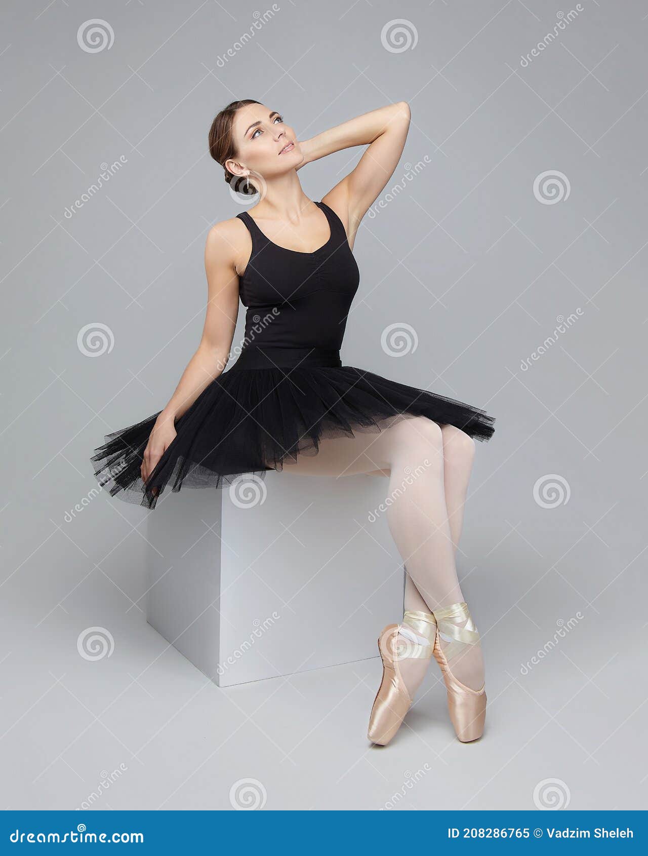 Attractive Poses Gracefully while Sitting on a Cube. Photo Shoot in the Studio on a White Background Stock Image - Image of elegance, exercise: 208286765
