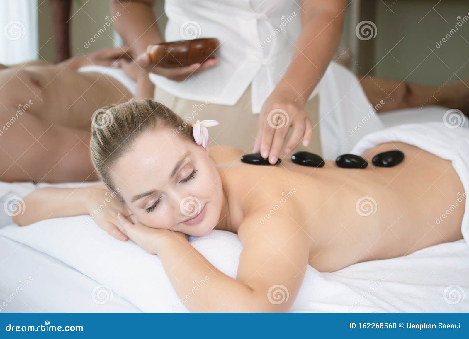 Attractive Beautiful Girl Lying On Massage Bed In Spa Sal