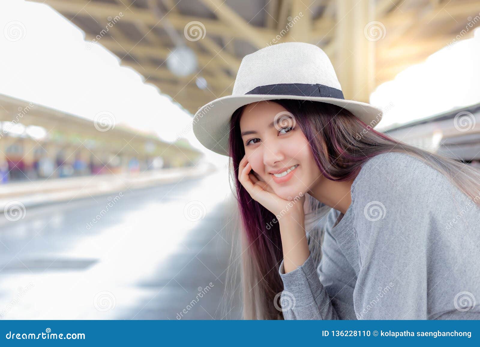attractive beautiful woman is waiting train for traveling around the city.