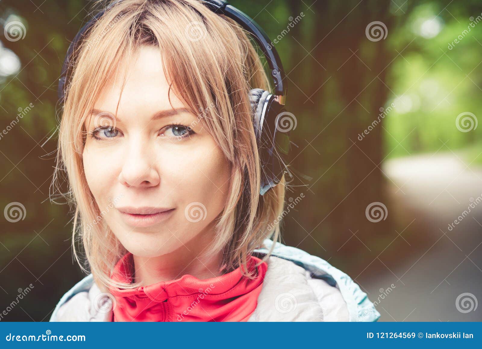Attractive Blond Woman In The Forest Close Up Portrait Of A Sporty Smiling Girl Listening To 