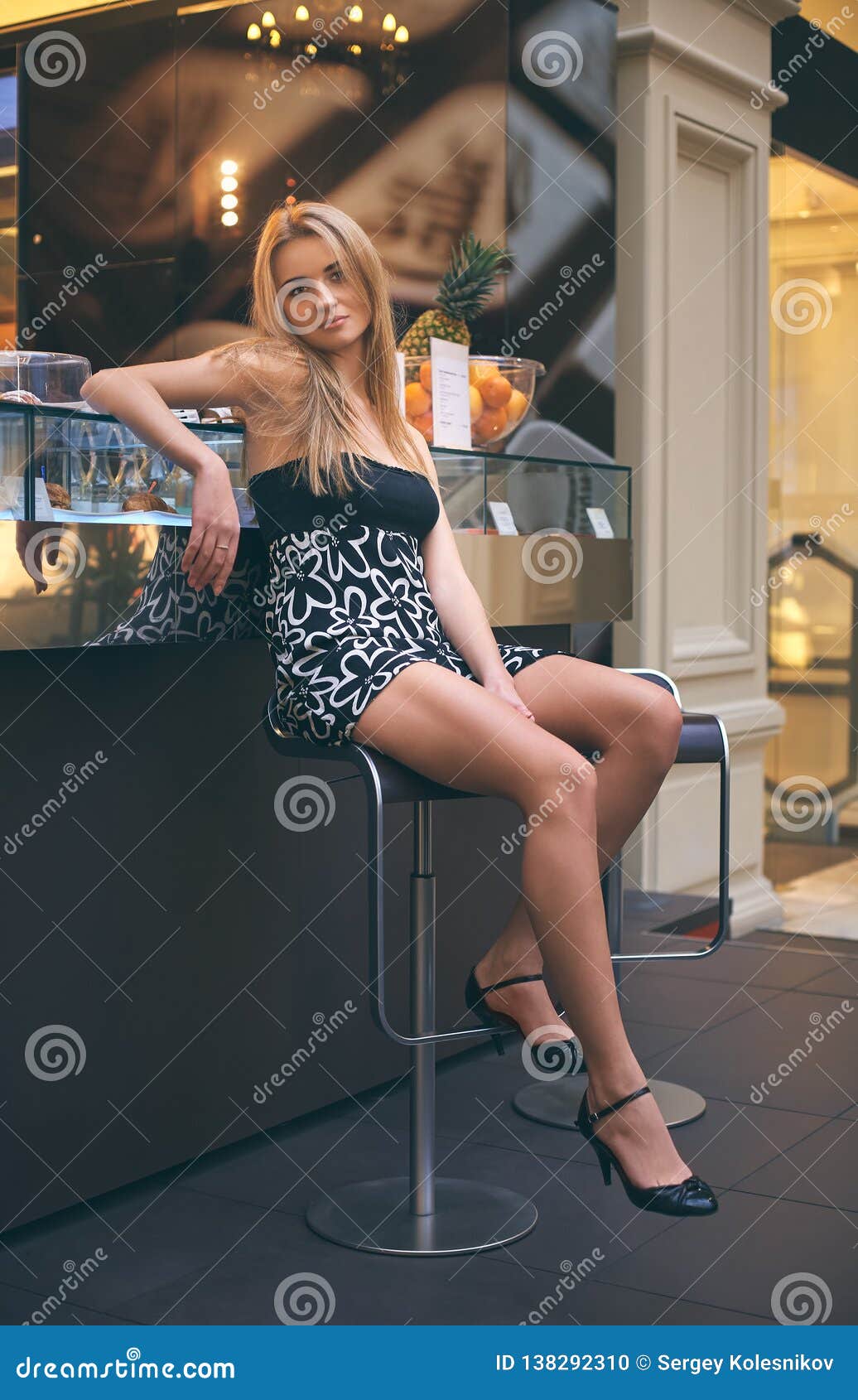 Attractive Blonde Girl With Long Hair Sitting On A High Bar Stool Stock Photo Image Of
