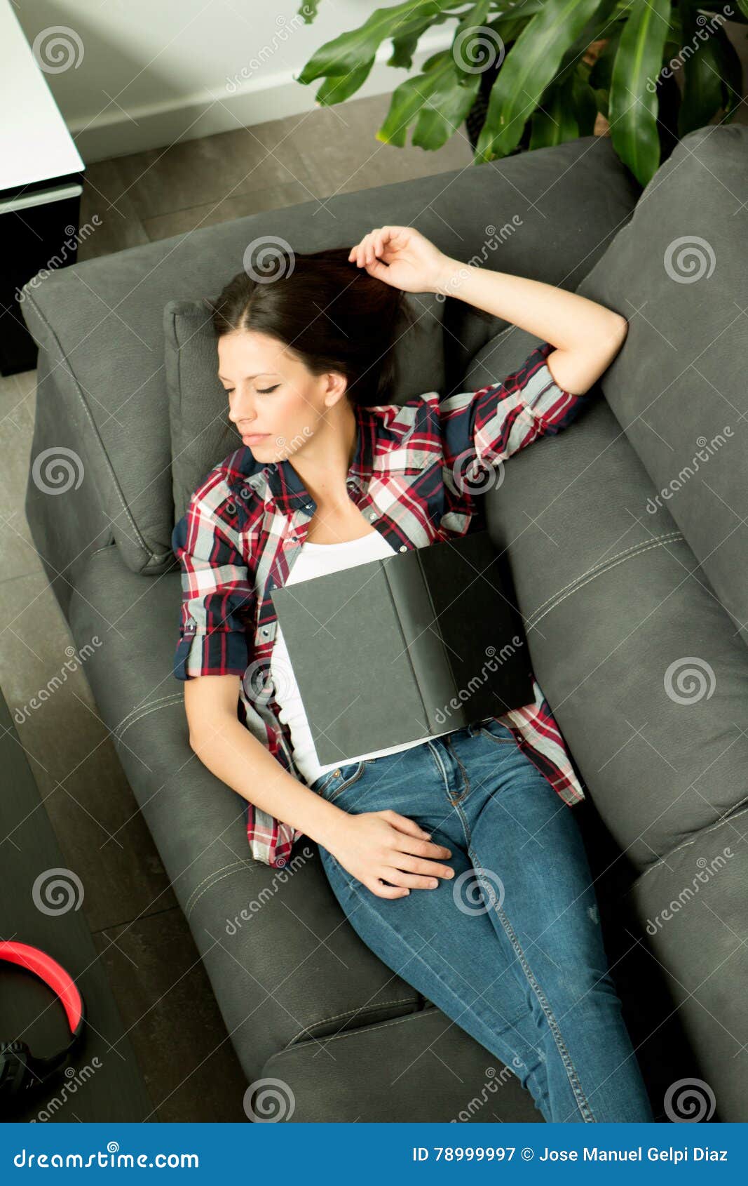 Attractive Brunette Girl Sleeping On The Sofa View From Above Stock